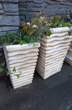 The Faraway Garden Waterfall Planter is a versatile pedestal planter with organic linear moulding on all sides. This impressive planter works wonderfully in a group on a patio or pool area or as part of a statement entrance. 