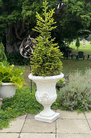 The Faraway Garden Ovid Urn is a large, elegant garden planter inspired by the classical Greek aesthetic with elaborate leaf moulding on the rim and around bowl. The detailed goat motif symbolises abundance, determination, health and vitality. This urn looks wonderful in a sepia wash for an instant aged effect.  This unique garden planter would look stunning as part of a group or positioned on a Faraway Garden pedestal and the focal point at the end of pathway or the centrepiece of a rose garden.