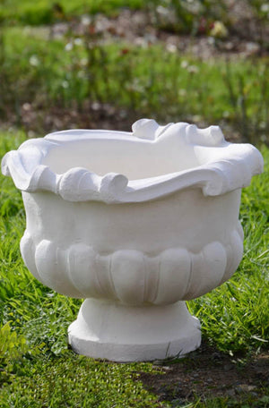 The Faraway Garden Grecian Urn is an elegant garden planter inspired by the classical aesthetic of Ancient Greece with its distinctive scrolling on the rim and gadrooning design on bowl. Perfect aged with our sepia wash.  This unique garden planter would look gorgeous as part of a group or positioned on one of Faraway Garden's pedestals.