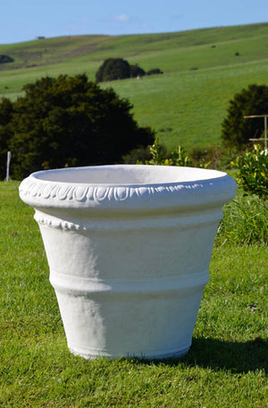The Faraway Garden Roman Pot is a large, elegant garden planter inspired by the classical Italian aesthetic with distinctive linear moulding around bowl and egg and dart pattern on rim.  This impressive garden planter looks stunning as part of a group or row; or as a focal point at the end of a walkway or as a pair flanking an entrance. An ideal planter for ornamental trees.